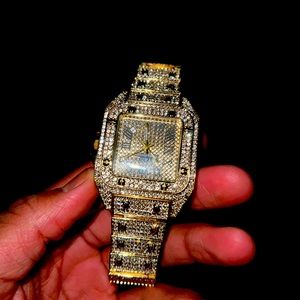 Golden watch with diamonds in it